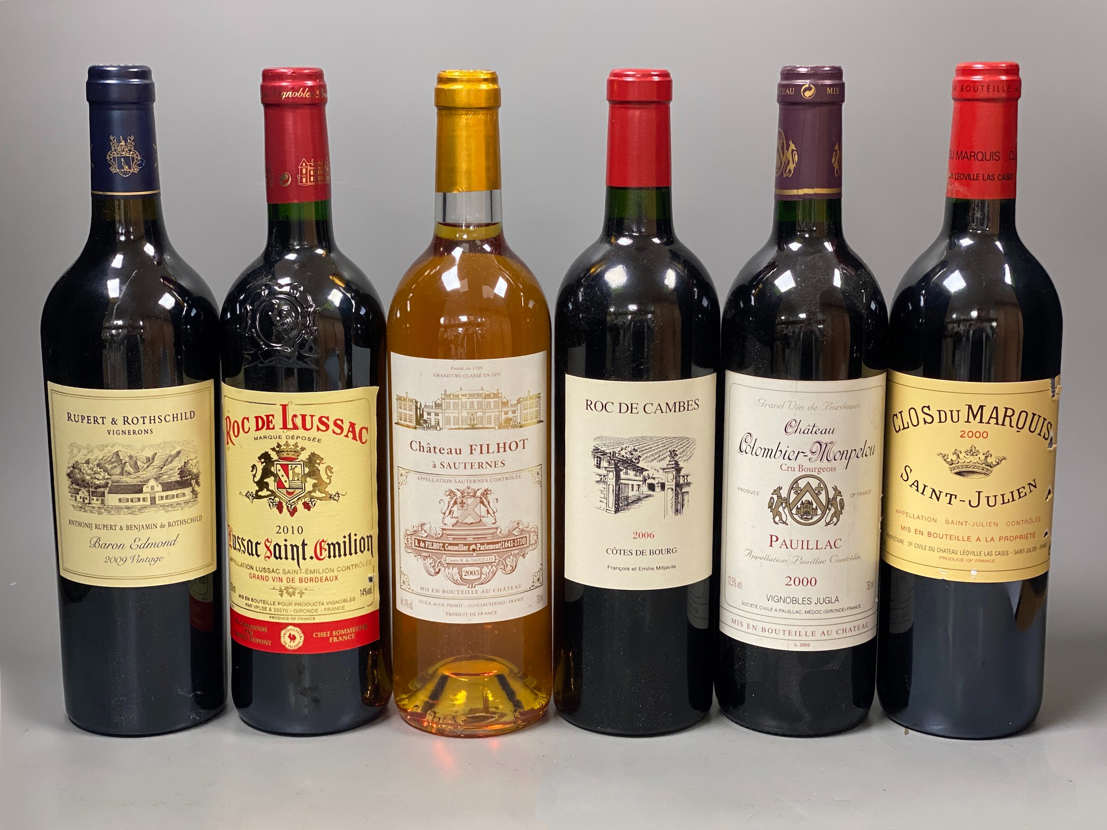 Six bottles of wine: Saint Emilion 2010, Saint Julien 2000, Pauillac 2000, Cotes de Bourg 2006, Sauternes 2003 and Vintage Baron Edmond 2009 (6)